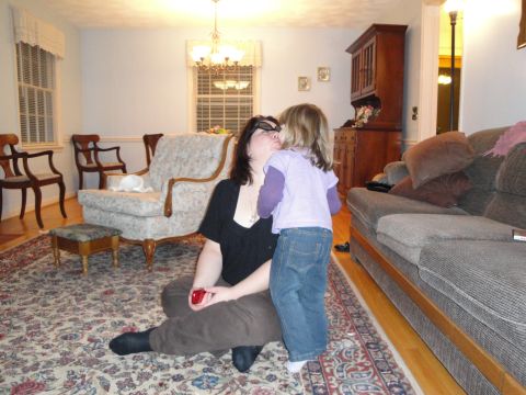 2000 Ford Crown Victoria - A woman and a child are in a living room, with a sofa and chairs visible.