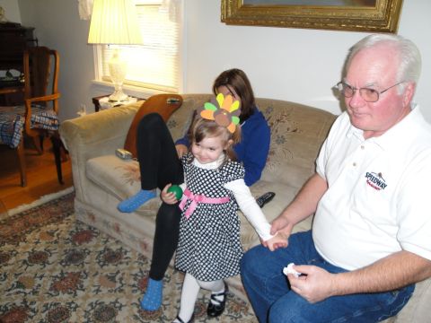 2000 Ford Crown Victoria - Family gathers indoors, with a child wearing a Thanksgiving turkey headband.