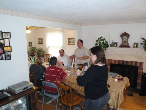 2000 Ford Crown Victoria - A group of people are enjoying a meal together around a decorated dining table.