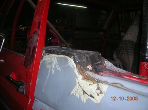1985 Ford Bronco - Bodywork in progress on a red vehicle interior, showing rust repair and preparation for paint.