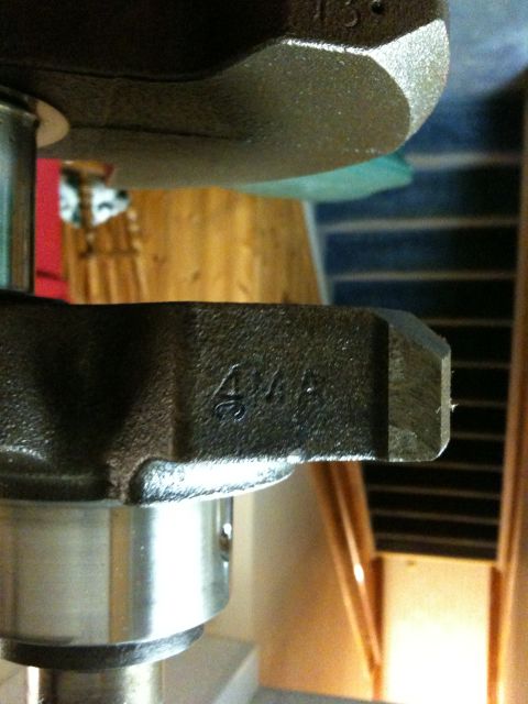 1972 Ford Ranchero - Close-up of a crankshaft with cast markings.