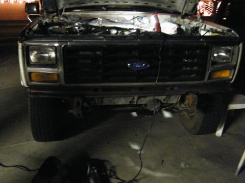 1982 Ford Bronco - Front view of a 1980 Ford Bronco with its hood open, revealing the engine compartment.