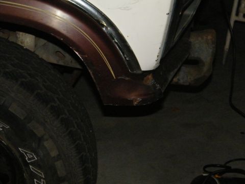 1982 Ford Bronco - Close-up of the front passenger side wheel well and fender flare on a 1982 Ford Bronco.