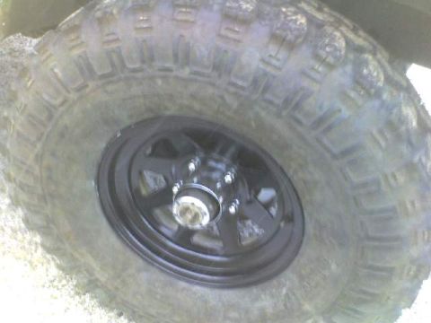 1989 Ford Bronco - A close-up view of a off-road tire and wheel assembly.
