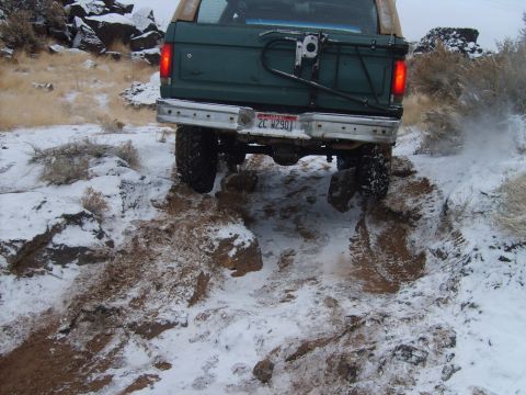 1989 Ford Bronco - This 1989 Ford Bronco navigates a snowy, rocky trail, kicking up dirt and snow.