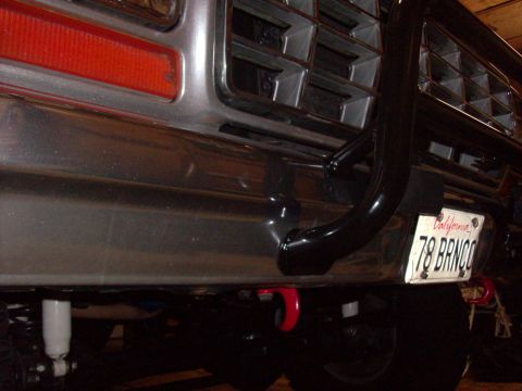 1978 Ford Bronco - Close-up of the front of a 1978 Ford Bronco, its grille, bumper, and a custom bull bar with a personalized license plate.