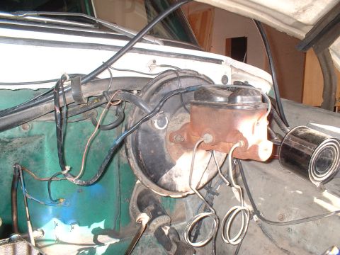 1978 Ford Bronco - Close-up view of the brake master cylinder and booster assembly, showing various hoses and wiring.
