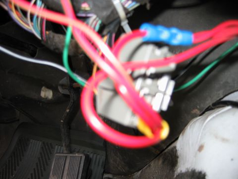 1992 Ford Bronco - Close-up view of a vehicle's interior wiring harness and fuse box connections.