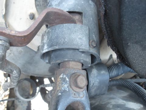 1990 Ford Bronco - This photo shows a close-up view of a steering column bracket and associated hardware.