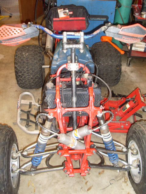 1987 Honda 250 R - Front view of an ATV's suspension and handlebars, showing aftermarket parts.