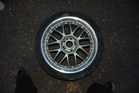 1997 Mazda MX-6 - Aftermarket alloy wheel and tire shown on the ground.
