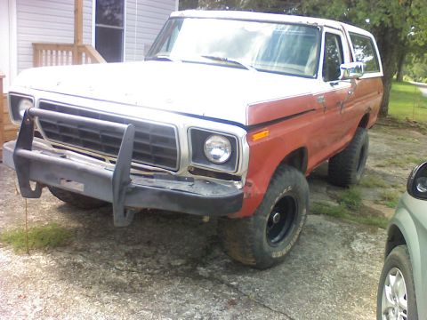 1993 Ford F-150 - This 1978 Ford Bronco is shown from a three-quarter front angle, a prominent brush guard and two-tone paint.