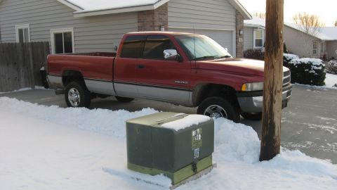 1997 Dodge 2500 - A red and silver 1997 Dodge 2500 pickup truck is parked in the snow.