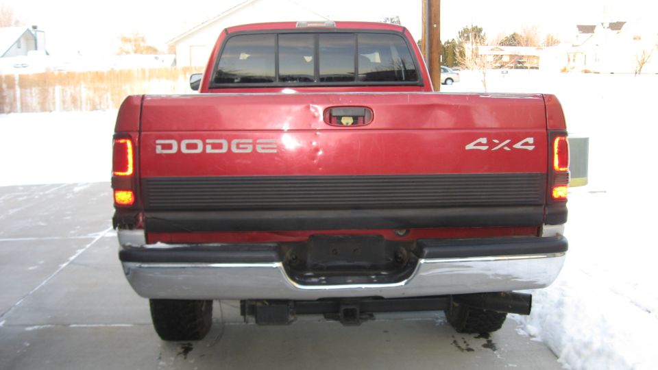 Rear view of a red 1997 Dodge 2500 pickup truck with a 4x4 decal