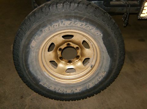 2000 Ford E350 - A close-up view of a single tire and wheel assembly, showing brand markings on the tire.