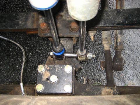 1989 Ford Bronco - Close-up of the undercarriage, showing suspension parts and shift levers, with a Supermotors.net watermark.