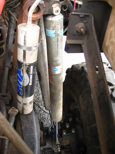 1989 Ford Bronco - Vehicle suspension with two shock absorbers, one is a FOX Racing Shox unit.