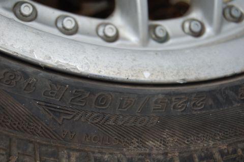 1997 Mazda MX-6 - A close-up shot focuses on the tire sidewall and a portion of the vehicle's wheel.