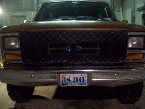1985 Ford Bronco - Front view of a Ford Bronco, likely from the early 1980s, with a custom quilted grille cover.