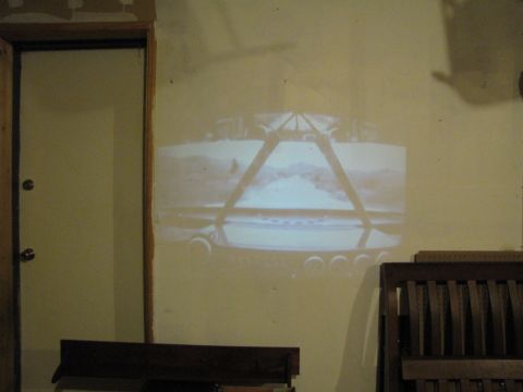 1984 Ford Bronco - A projected image shows the rear of an SUV, possibly from the early 1980s, with distinctive round taillights.
