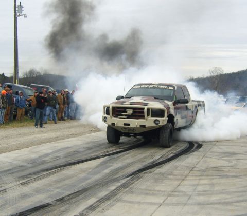 2007 Ford Mustang - A Ford F-Series truck performs a burnout, kicking up a large amount of smoke during an event.