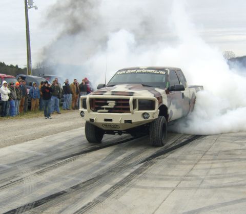 2007 Ford Mustang - Custom Ford F-Series truck performing a burnout, generating large amounts of smoke.