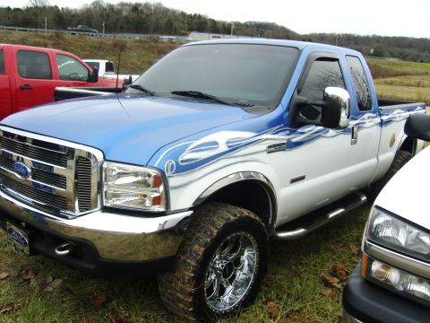 2007 Ford Mustang - Custom painted Ford F-Series truck parked outdoors with other vehicles nearby.