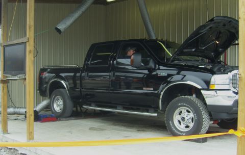 2007 Ford Mustang - Black Ford F-350 Super Duty truck undergoing testing on a dynamometer with its hood open.