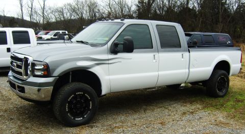 2007 Ford Mustang - This Ford F-250 Super Duty pickup truck features a two-tone paint scheme with flame decals and a black aftermarket grille.