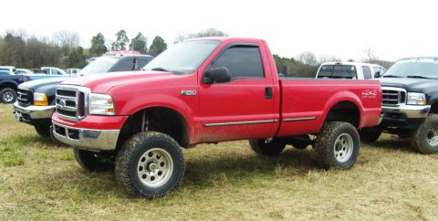 2007 Ford Mustang - This red Ford F-250 pickup truck, seen from a 3q-front angle, has an F-250 badge indicating its model year.