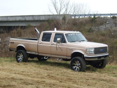 2007 Ford Mustang - This lifted Ford F-250 Super Duty pickup features dual exhaust stacks and custom wheels, with 'Power Stroke' text visible on the windshield.