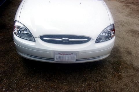 2000 Ford Taurus - The front grille and headlights of a white 2000 Ford Taurus are visible.