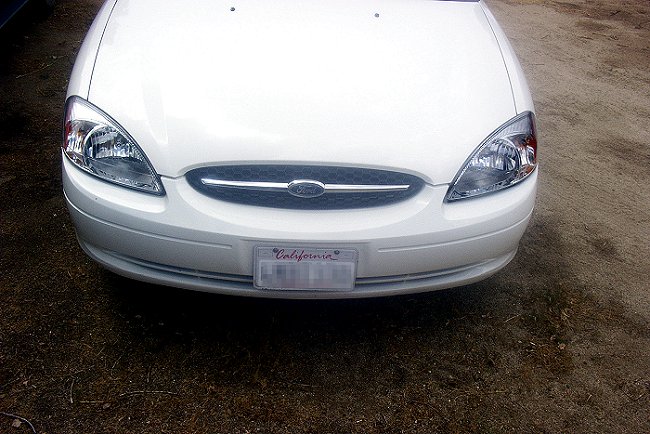 Front view of a white 2000 Ford Taurus with a California license plate