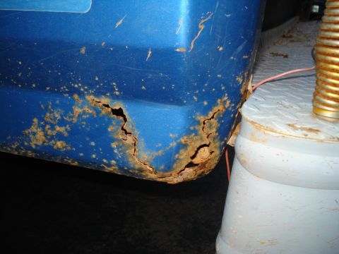 1985 Ford F-150 - Significant rust is visible on the lower rear corner of the blue truck bed, consistent with a 1985 Ford F-150.