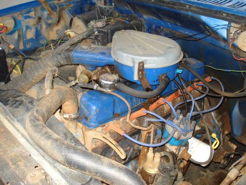 1985 Ford F-150 - Close-up view of a vehicle's engine bay, showing various components and wiring.