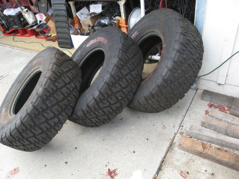 1986 Ford Bronco - A set of four off-road tires are shown, with "GRABBER" visible on the sidewalls.