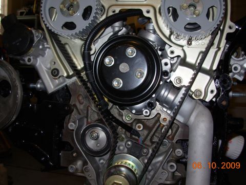 1991 Ford Taurus - Close-up view of an engine's timing belt and water pump system, with a date stamp of 06.10.2009.