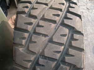 1986 Ford Bronco - Tire tread detail, likely from an off-road vehicle, with a website watermark.