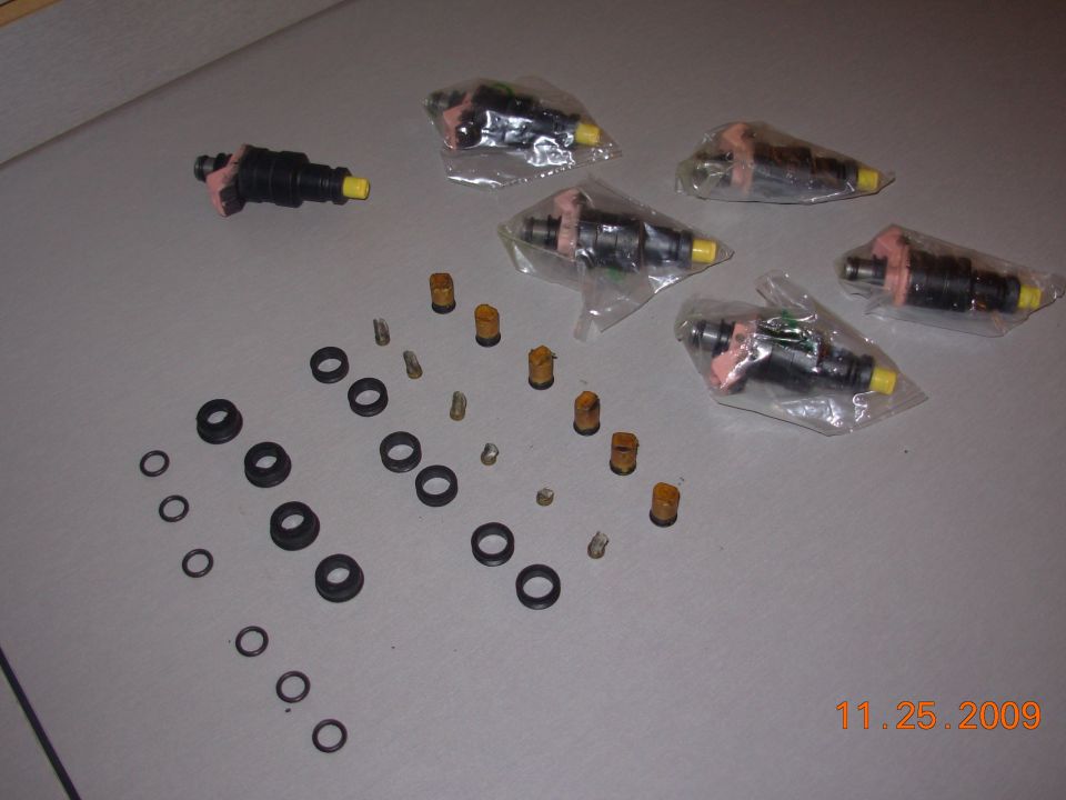 A set of fuel injectors that were tested cleaned, along with new screen and seals.