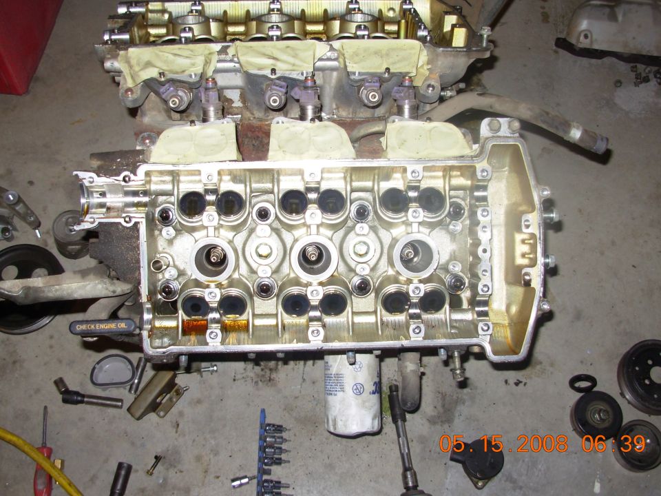 Engine block with valve cover removed, showing cylinders and valves