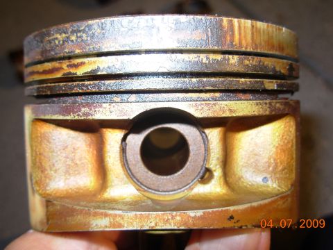 1991 Ford Taurus - A close-up view of a worn piston, showing rust and discoloration.