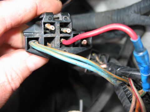1992 Ford Bronco - Close-up of a hand holding an electrical connector with multiple wires, showing a Supermotors.net watermark.