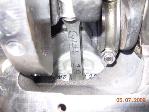 1991 Ford Taurus - Close-up view of engine internals, showing a connecting rod and crankshaft bearings with markings.