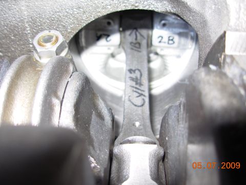 1991 Ford Taurus - Close-up view of an engine cylinder with a piston rod and markings.