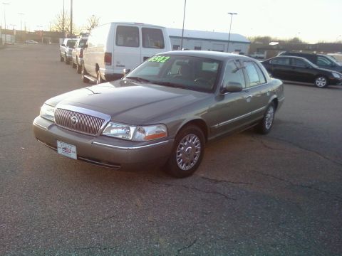 2000 Mercury Grand Marquis - This 2000 Mercury Grand Marquis is shown from the front three-quarter angle, with a price tag visible on the windshield.