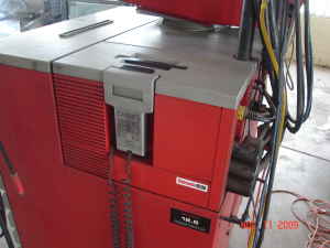 1993 Ford Taurus - A close-up view of a red tire changing machine, likely found in a mechanic's shop.