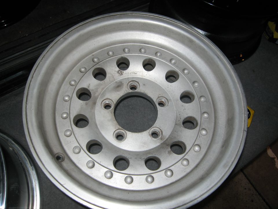 Aluminum wheel with multiple bolt holes and raised studs