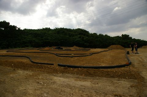 1986 Ford Bronco - RC car track construction site with two people observing the progress.