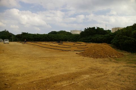 1986 Ford Bronco - An outdoor RC car track is set up in a dirt lot with a small white van in the distance.