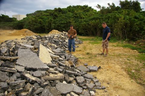 1986 Ford Bronco - Two men observe a large pile of broken asphalt on a construction site.